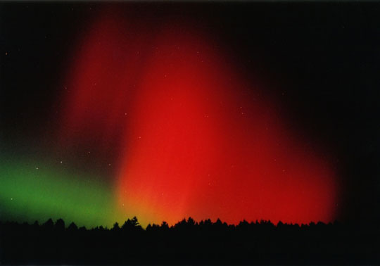 red and green northern lights in a night sky