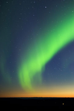 green northern lights at twilight