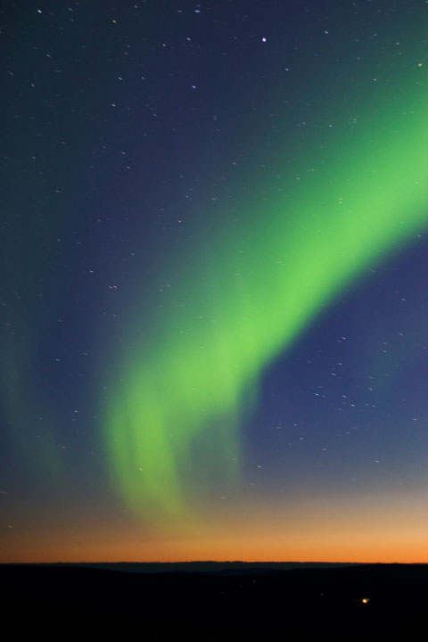 green northern lights at twilight